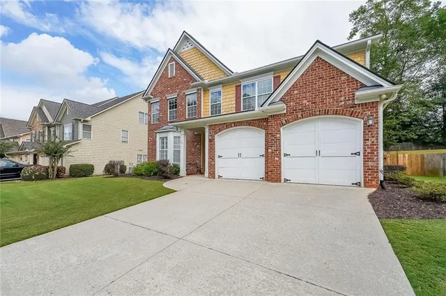 a front view of a house with a yard and garage