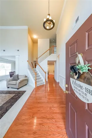 a living room with furniture wooden floor and a large window