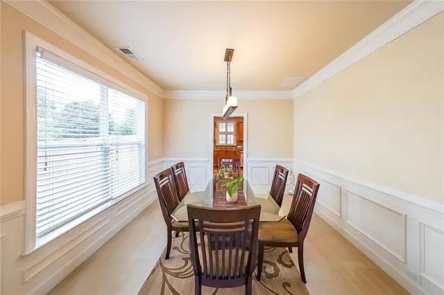 a kitchen with stainless steel appliances granite countertop a refrigerator a sink dishwasher a stove and white countertops with wooden floor