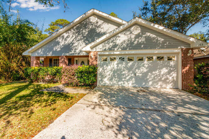 a front view of house along with trees