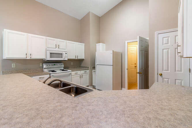 122 Bayou Landing Road Miramar Beach, FL 32550 - Photo 13 of 27 a kitchen with stainless steel appliances a refrigerator sink and white cabinets