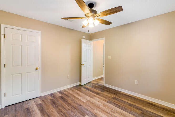 122 Bayou Landing Road Miramar Beach, FL 32550 - Photo 19 of 27 an empty room with a chandelier fan and wooden floor
