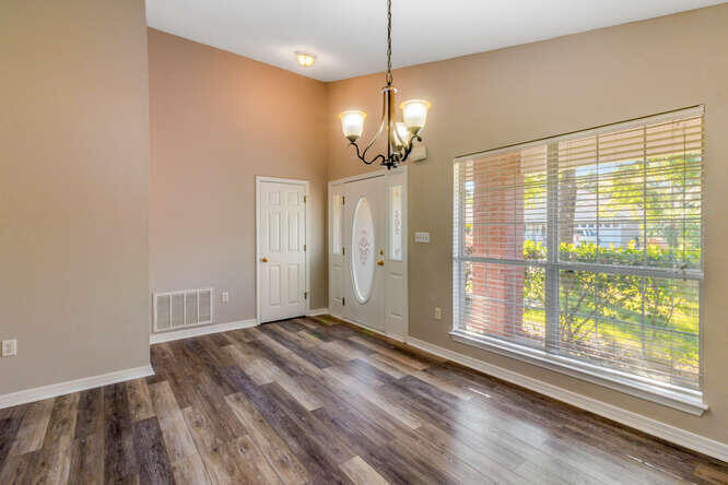 122 Bayou Landing Road Miramar Beach, FL 32550 - Photo 2 of 27 a view of a livingroom with a chandelier fan and a large window
