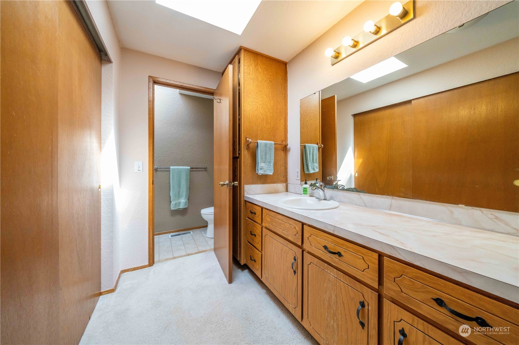 414 169th Street Southeast Bothell, WA 98012 - Photo 13 of 24 a spacious bathroom with a double vanity sink and a mirror