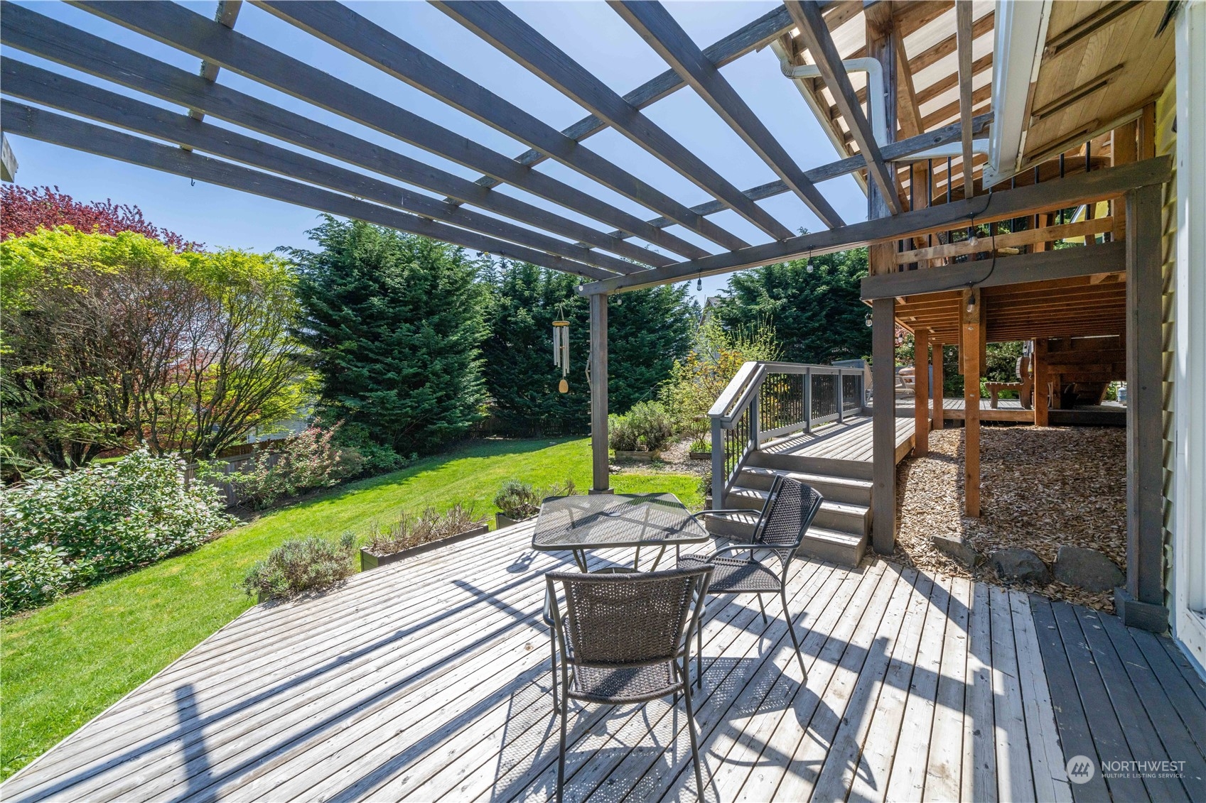 414 169th Street Southeast Bothell, WA 98012 - Photo 20 of 24 a view of a patio with table and chairs potted plants with wooden floor and fence