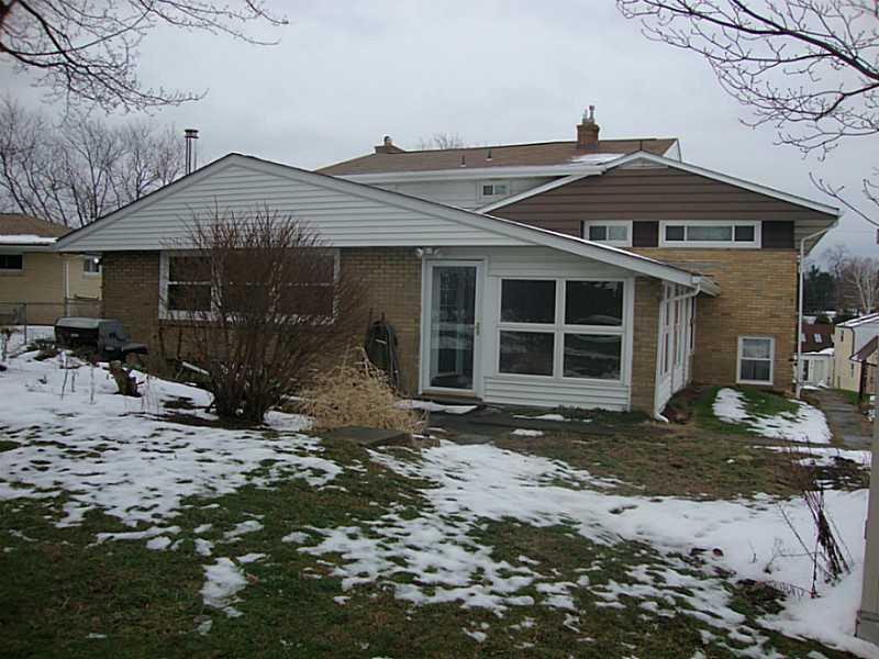 78 Bellview Circle McKees Rocks, PA 15136 - Photo 22 of 22 Exterior Back. View from the yard of back of the house, patio and sunroom.