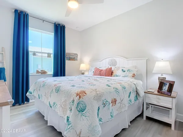 a bedroom with a bed and a lamp with window