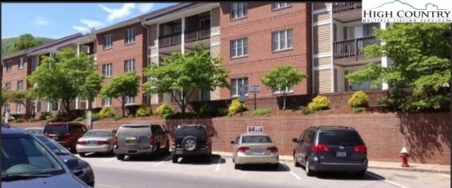a couple of cars parked in front of a building