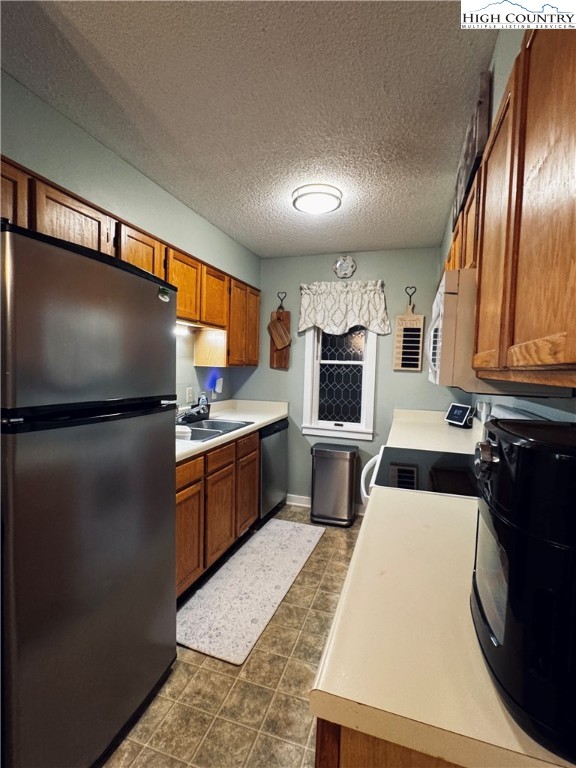 116 Grand Boulevard Boone, NC 28607 - Photo 13 of 14 a kitchen with stainless steel appliances kitchen island granite countertop a refrigerator a sink a stove and microwave