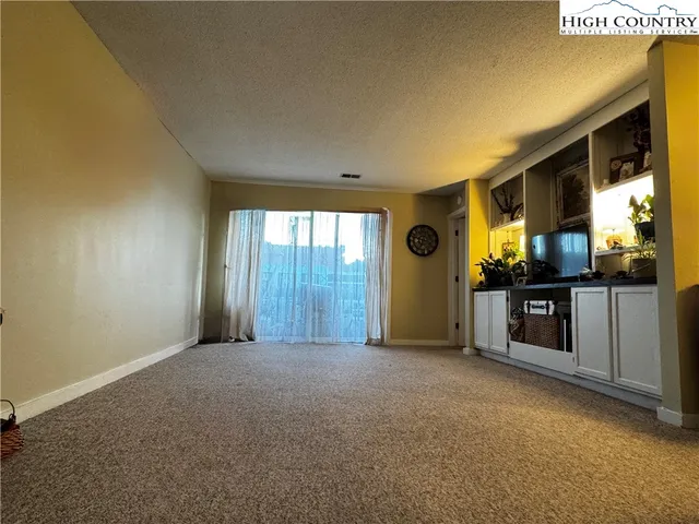 a view of a big room with windows and cabinet