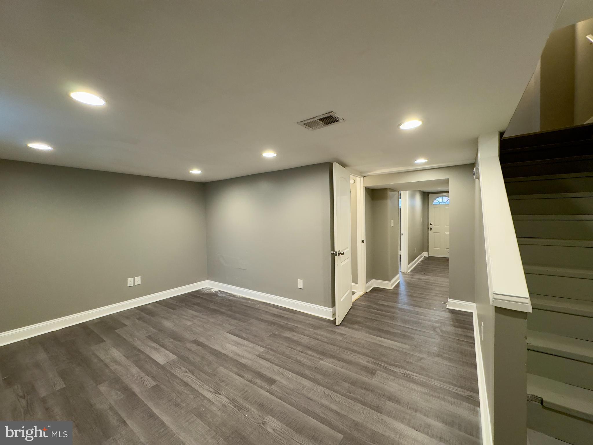 820 Bradhurst Road Baltimore, MD 21212 - Photo 14 of 20 an empty room with wooden floor and entryway
