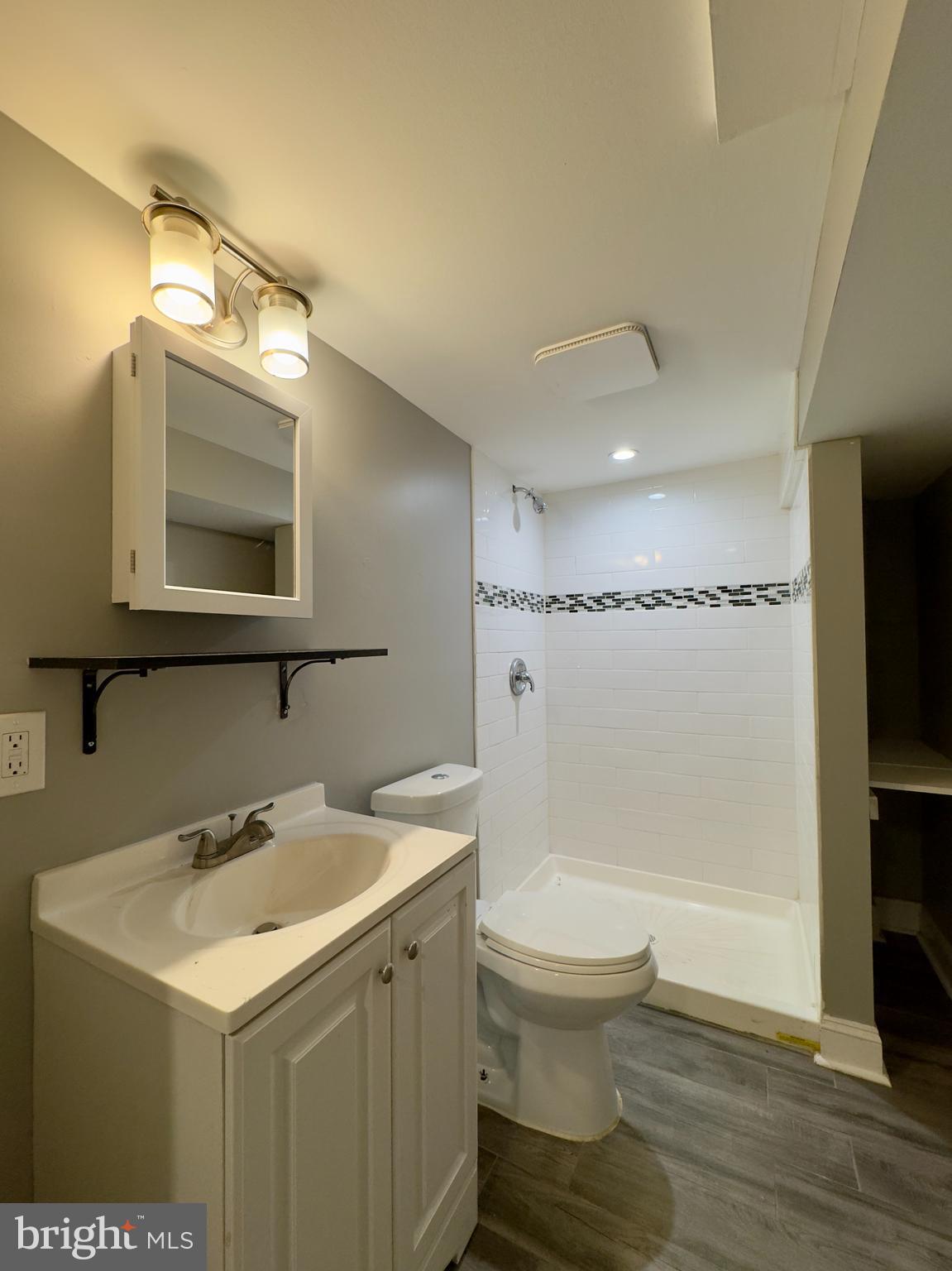 820 Bradhurst Road Baltimore, MD 21212 - Photo 17 of 20 a bathroom with a sink a toilet and shower