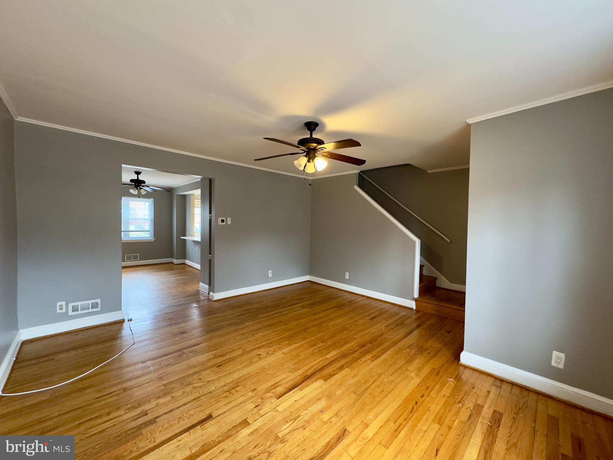 820 Bradhurst Road Baltimore, MD 21212 - Photo 2 of 20 a view of livingroom with hardwood floor and a ceiling fan