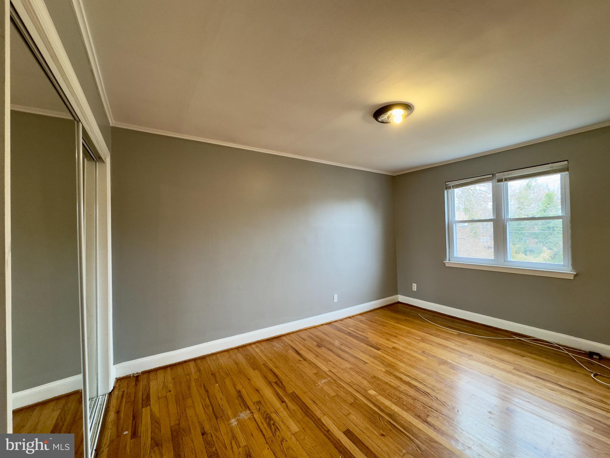 820 Bradhurst Road Baltimore, MD 21212 - Photo 10 of 20 an empty room with wooden floor and windows