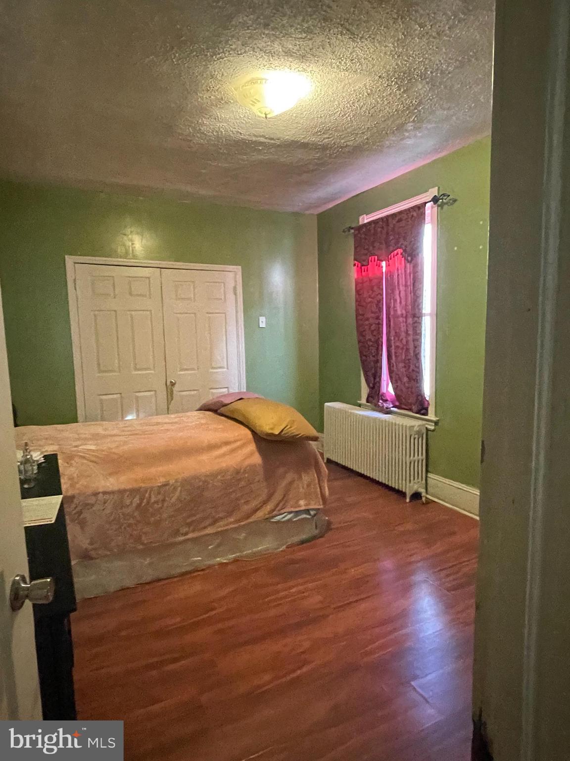 a bedroom with a bed and a mirror