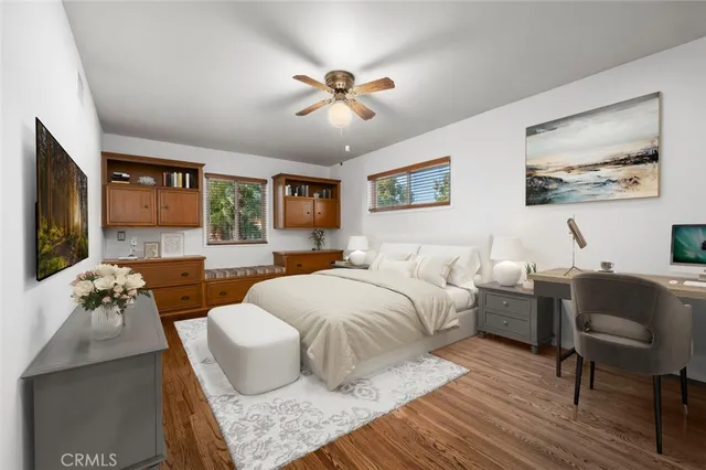 an empty room with wooden floor and fireplace
