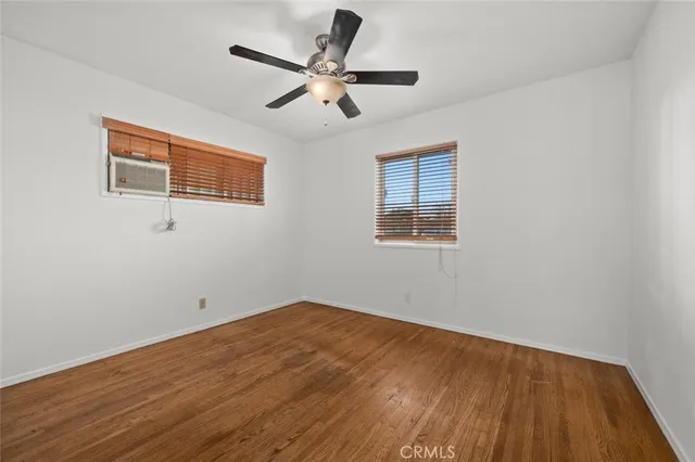 a backyard of a house with barbeque oven table and chairs
