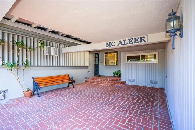 a backyard of a house with barbeque oven table and chairs