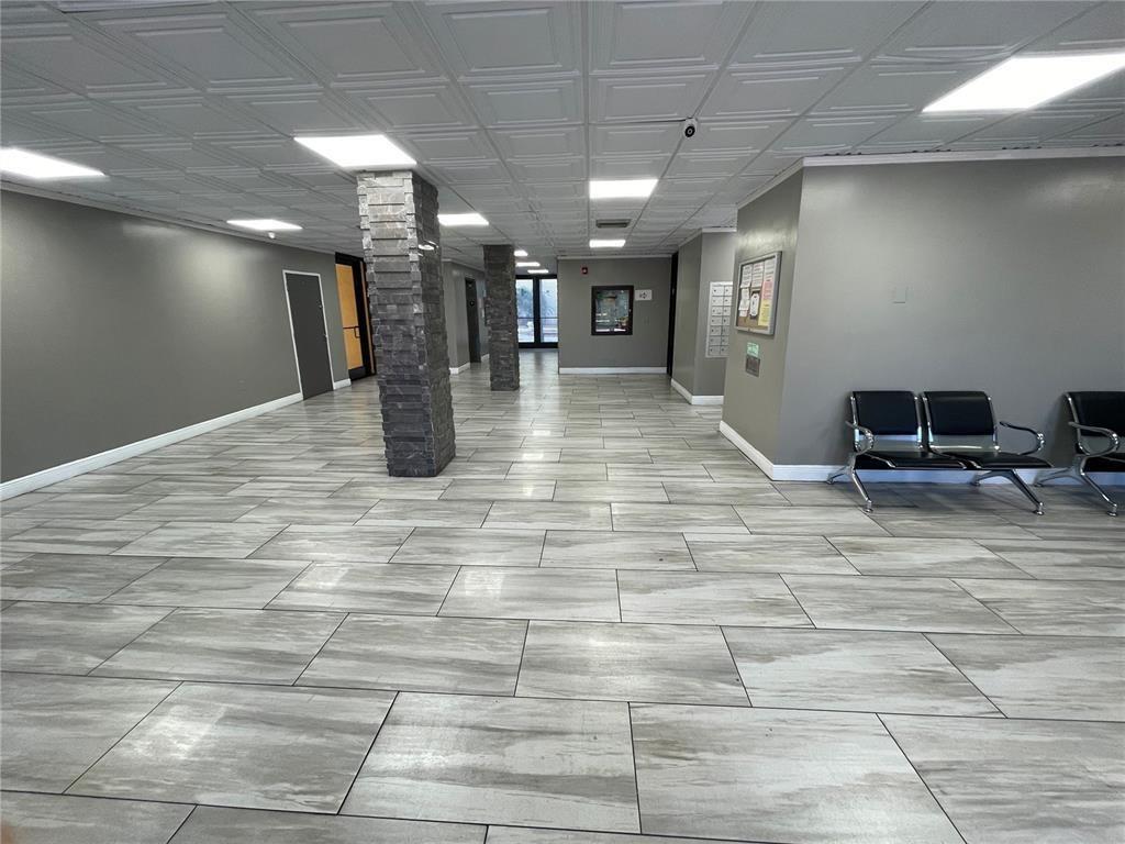 15600 Northwest 7th Avenue, Unit 606 Miami, FL 33169 - Photo 12 of 13 a view of a hall with many windows