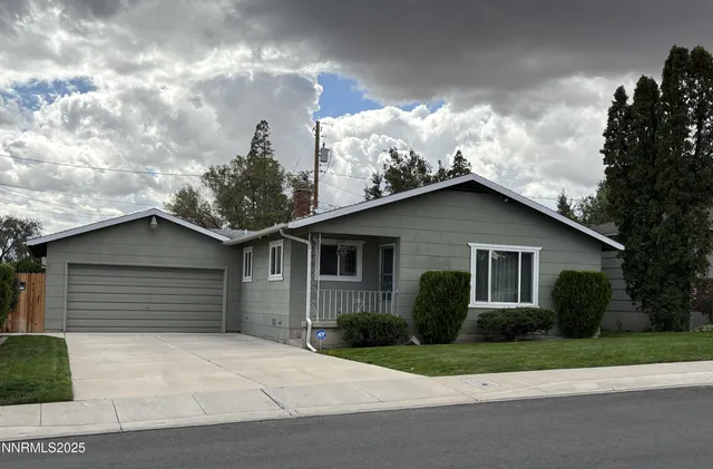 a view of a house with a yard and garage