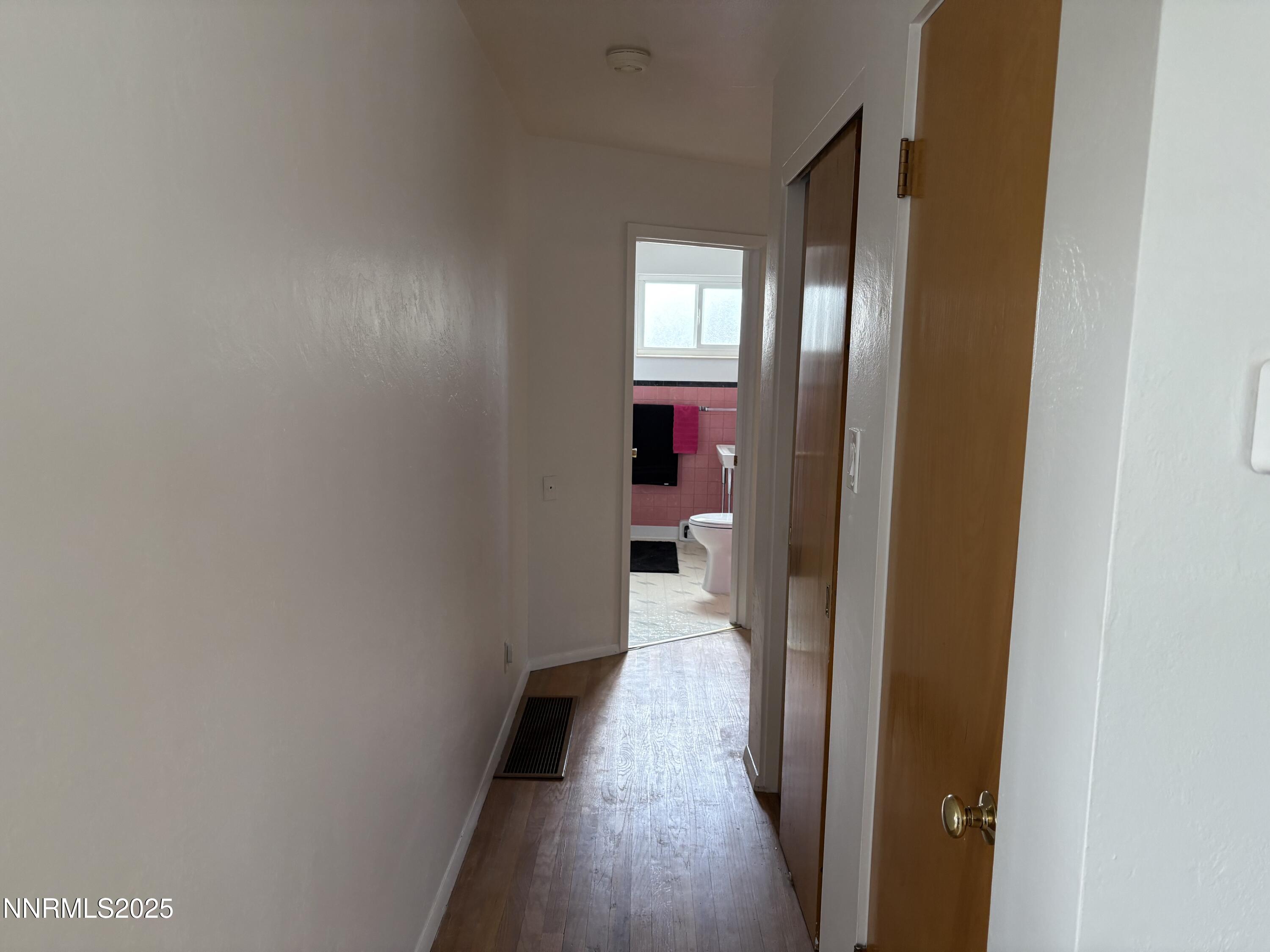230 Glenmanor Drive Reno, NV 89509 - Photo 12 of 28 a view of a hallway with wooden floor and a bathroom