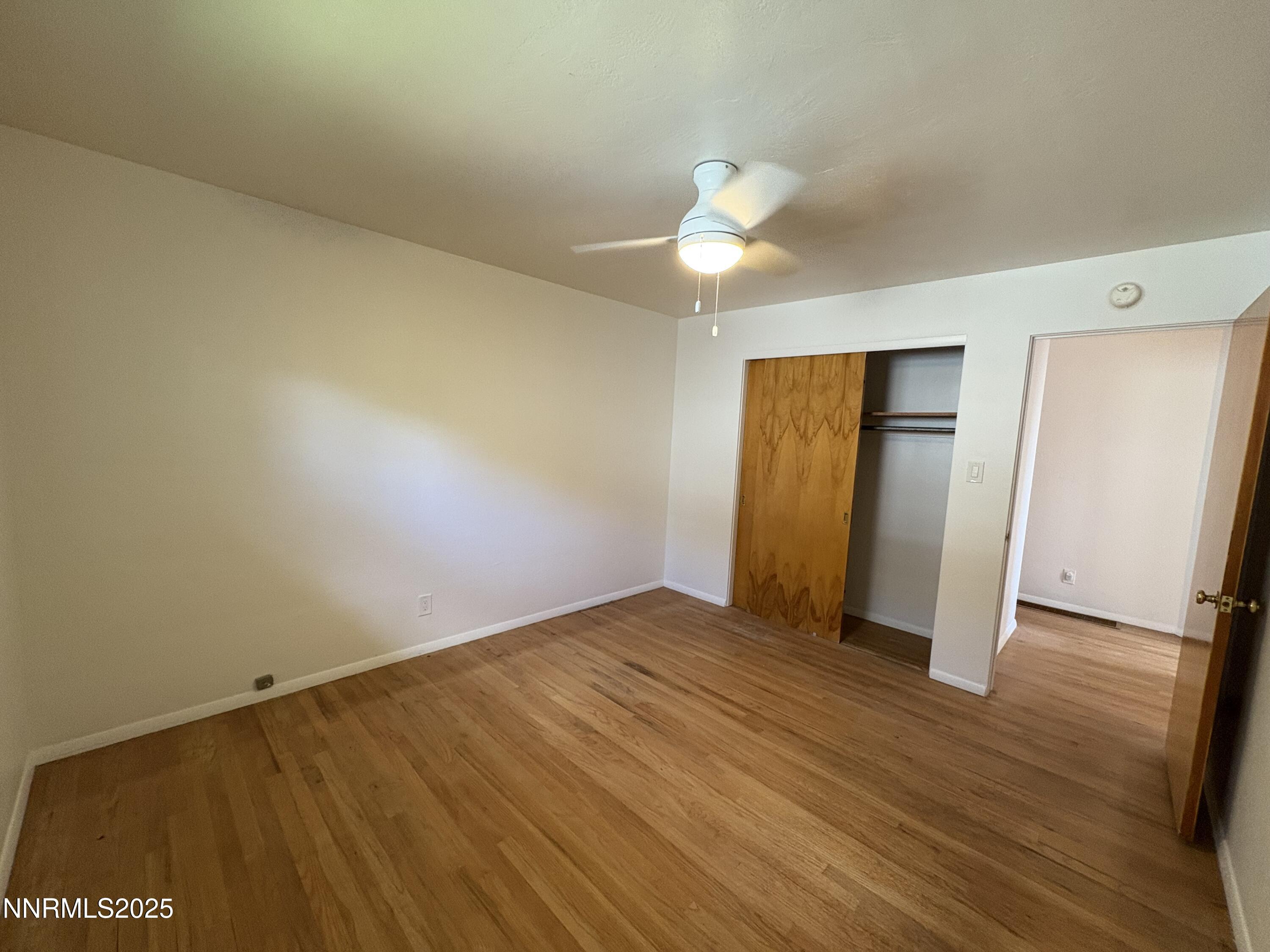 230 Glenmanor Drive Reno, NV 89509 - Photo 13 of 28 a view of an empty room with wooden floor and closet
