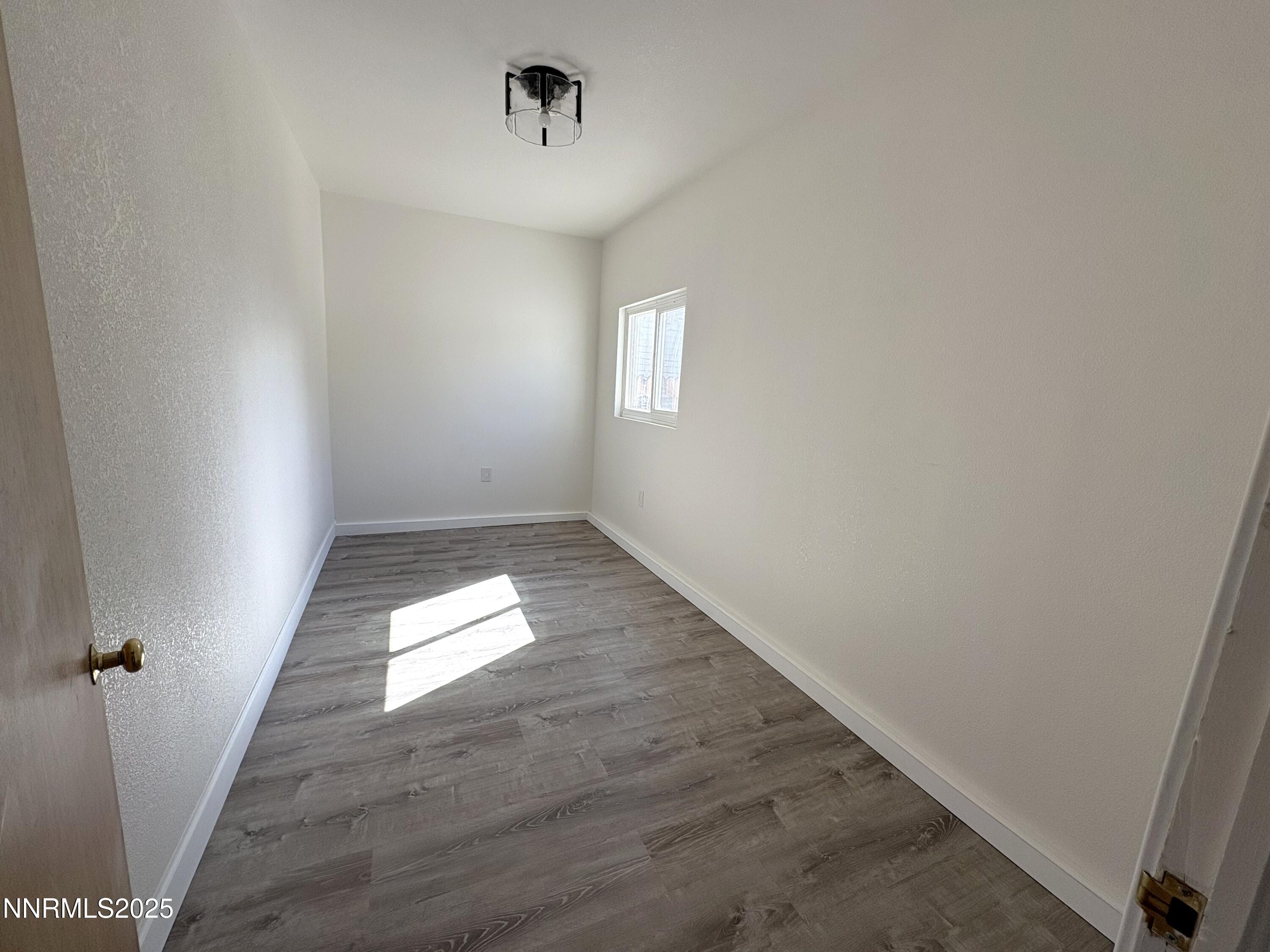 230 Glenmanor Drive Reno, NV 89509 - Photo 19 of 28 wooden floor in an empty room with a window