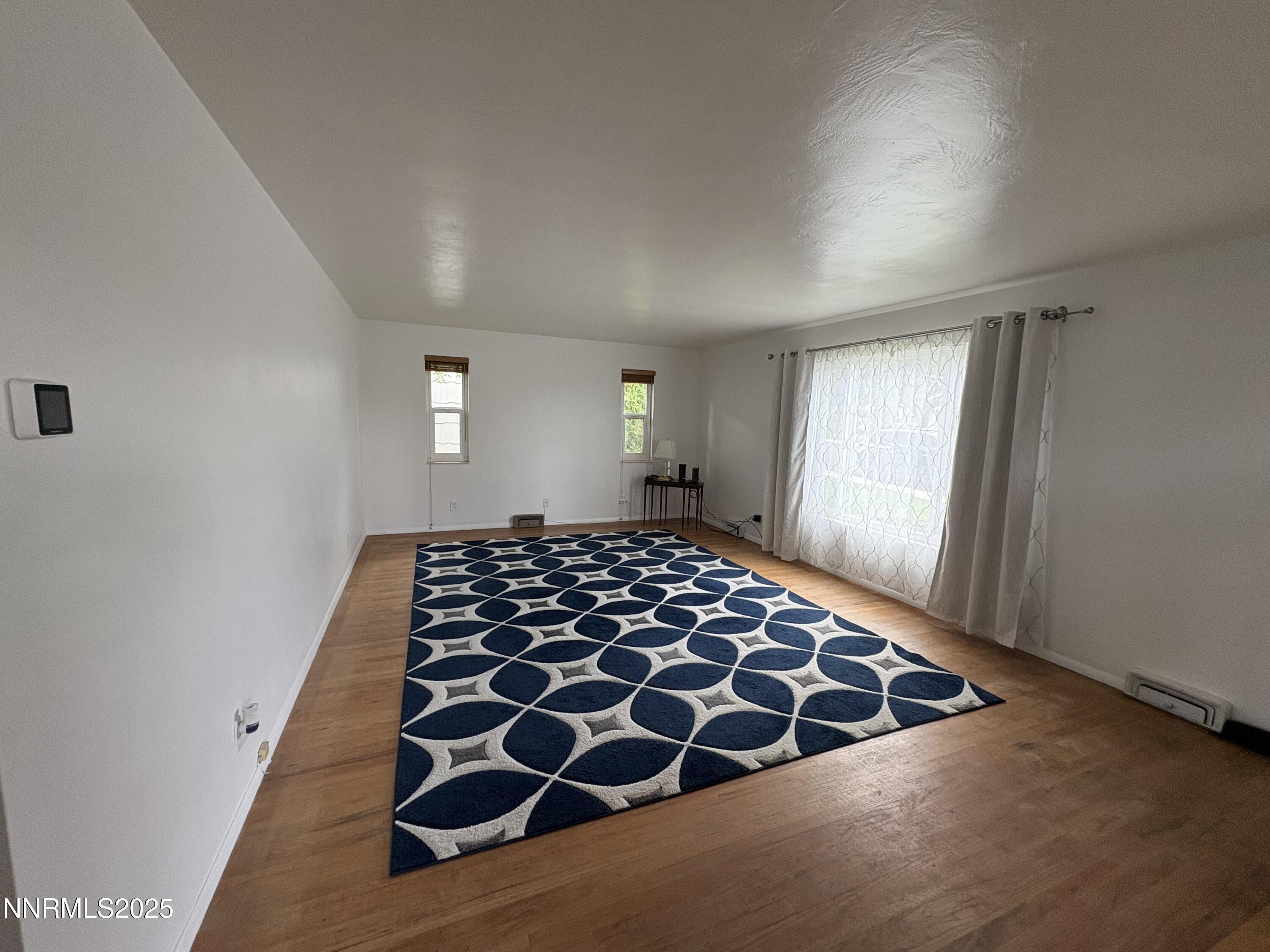230 Glenmanor Drive Reno, NV 89509 - Photo 5 of 28 a bedroom with wooden floor and window