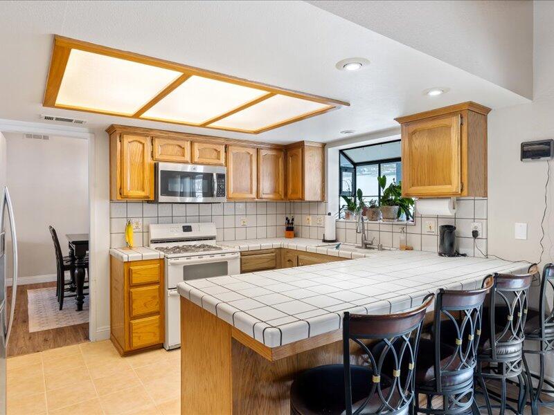 24140 Deertrail Drive Tehachapi, CA 93561 - Photo 12 of 44 a kitchen with a stove a sink and a refrigerator