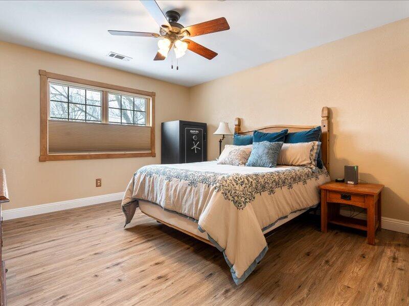 24140 Deertrail Drive Tehachapi, CA 93561 - Photo 13 of 44 a bedroom with a large bed and a window