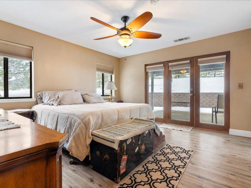 24140 Deertrail Drive Tehachapi, CA 93561 - Photo 16 of 44 a bedroom with a bed and wooden floor