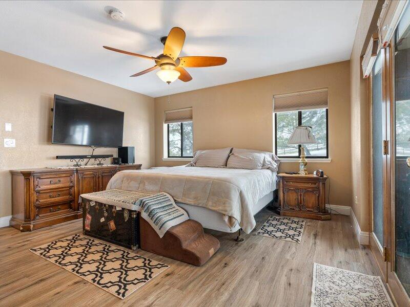 24140 Deertrail Drive Tehachapi, CA 93561 - Photo 17 of 44 a spacious bedroom with a bed and a flat screen tv
