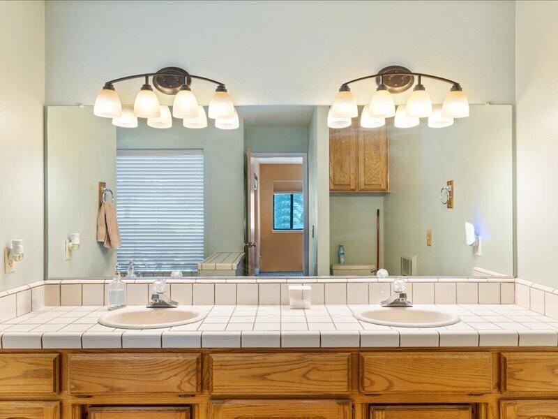 24140 Deertrail Drive Tehachapi, CA 93561 - Photo 18 of 44 a bathroom with a sink and a mirror
