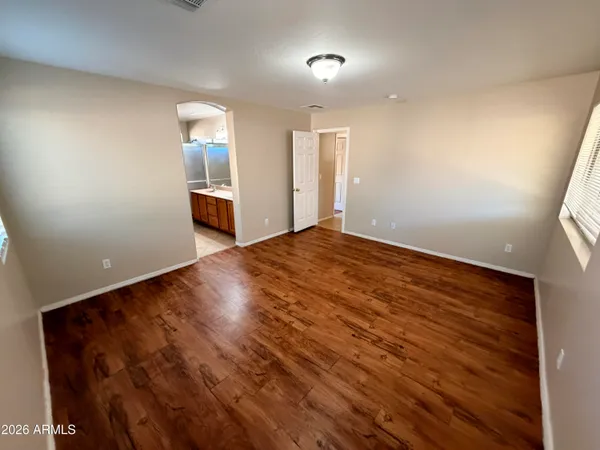 a view of a livingroom with wooden floor and staircase