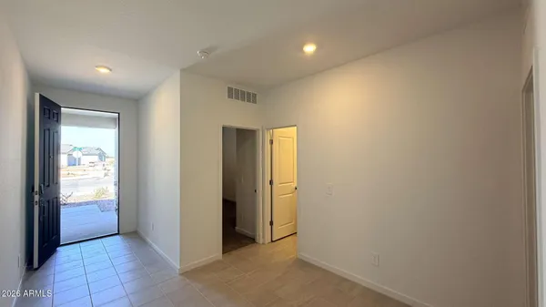 an empty room with windows and closet