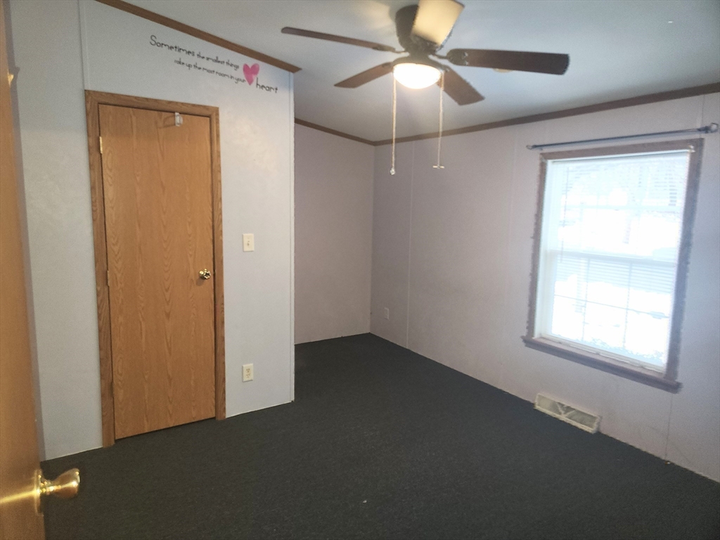 8 Chesapeake Road Holbrook, MA 02343 - Photo 19 of 27 an empty room with a window and a fan