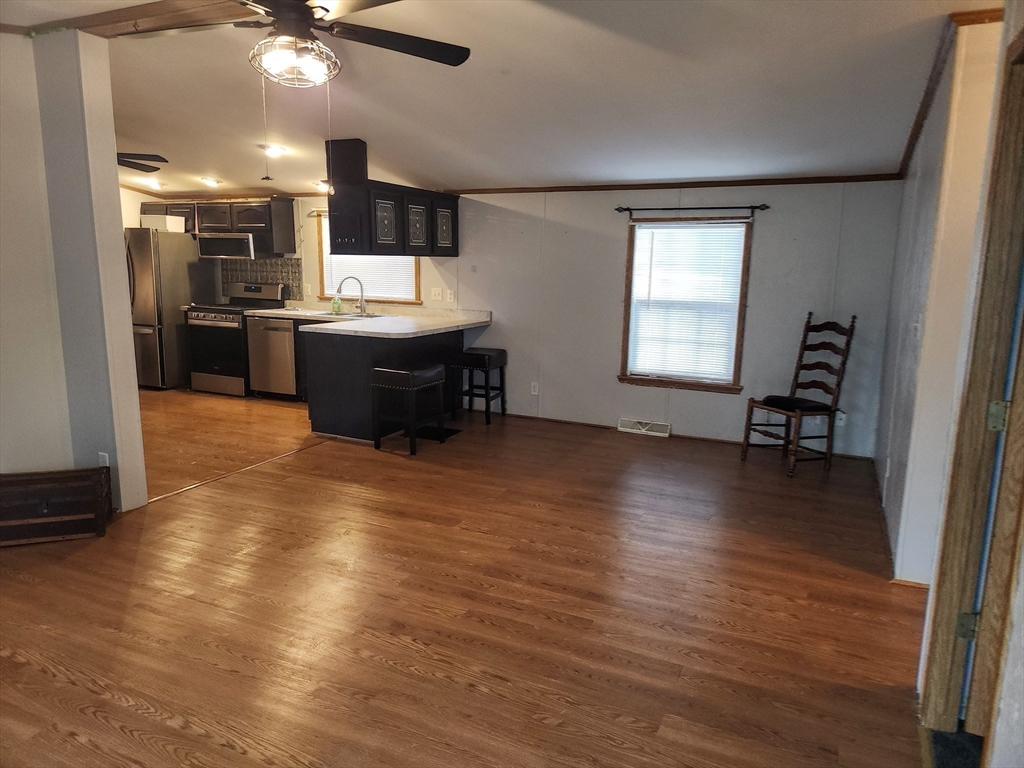 8 Chesapeake Road Holbrook, MA 02343 - Photo 9 of 27 a view of kitchen and living room with wooden floor