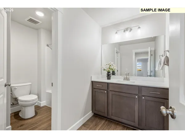 a bathroom with a toilet sink and a mirror