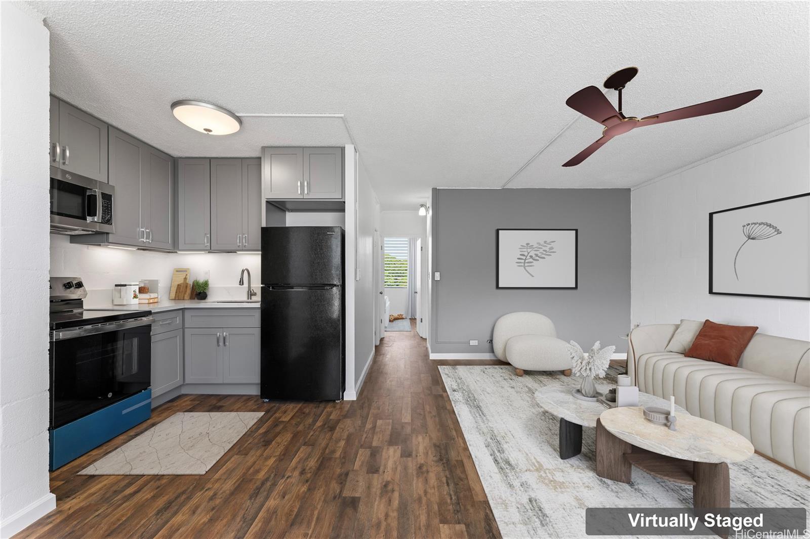 94-249 Waikele Road, Unit A206 Waipahu, HI 96797 - Photo 1 of 1 a kitchen with a refrigerator microwave and stove