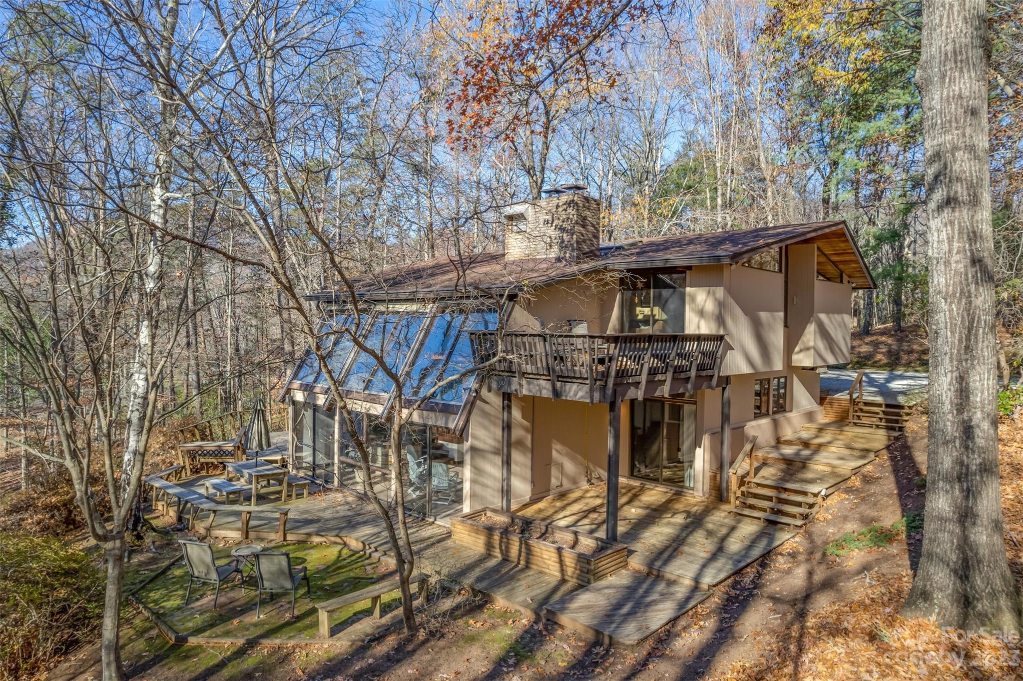548 Howard Gap Road Tryon, NC 28782 - Photo 1 of 48 a view of a large building with a bench and trees