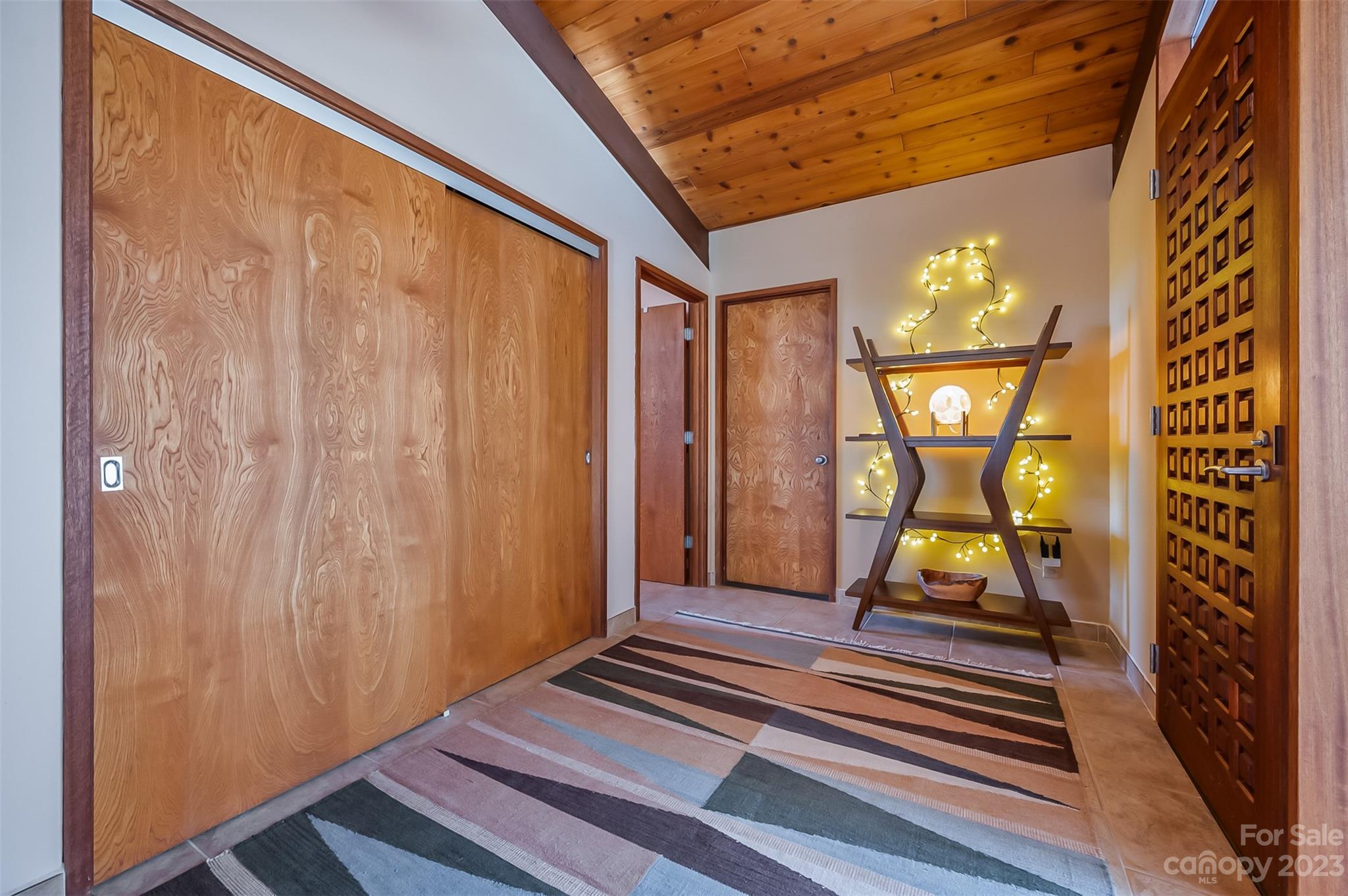 548 Howard Gap Road Tryon, NC 28782 - Photo 11 of 48 a view of a hallway with wooden floor and a bathroom view