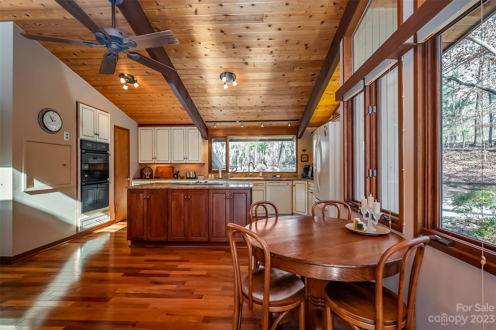 548 Howard Gap Road Tryon, NC 28782 - Photo 18 of 48 a view of a dining room with furniture window and wooden floor