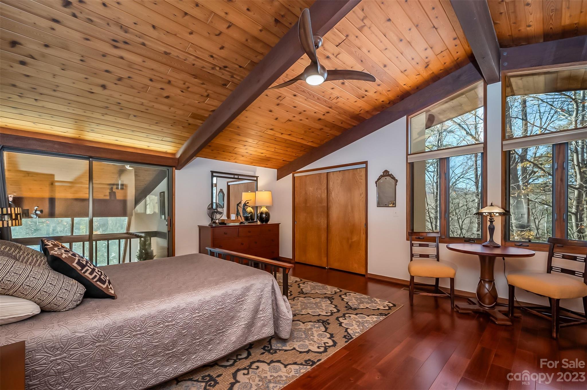 548 Howard Gap Road Tryon, NC 28782 - Photo 23 of 48 a bedroom with furniture large window and wooden floor