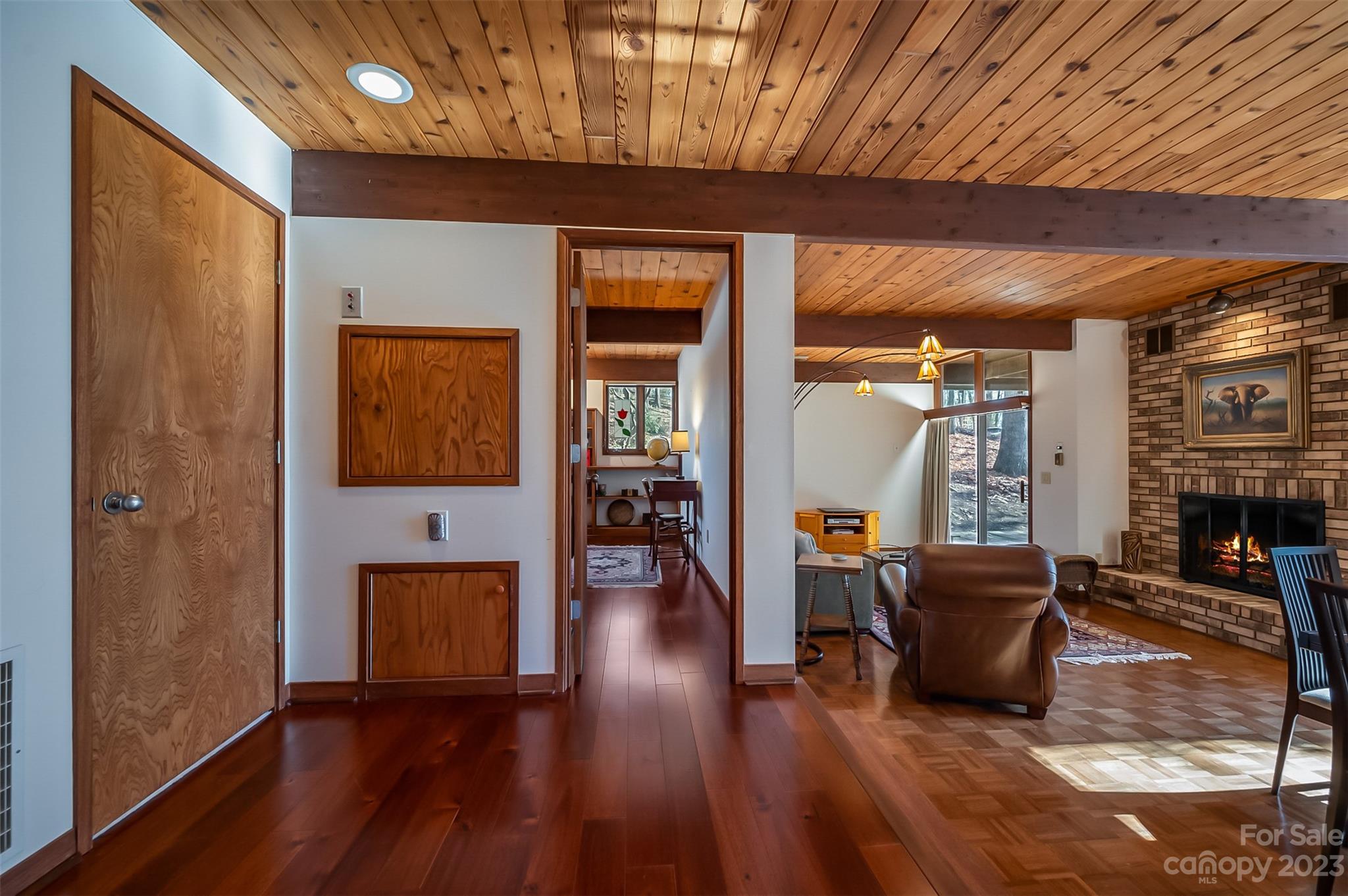 548 Howard Gap Road Tryon, NC 28782 - Photo 28 of 48 a living room with furniture a fireplace and wooden floor