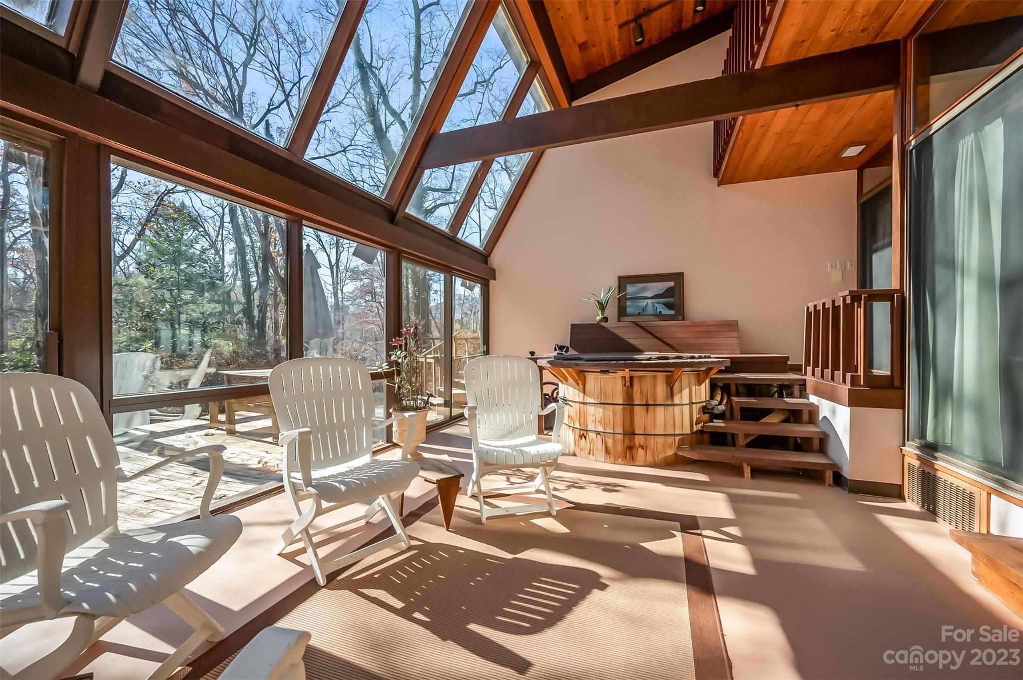 548 Howard Gap Road Tryon, NC 28782 - Photo 33 of 48 a view of a living room with furniture water view and large windows