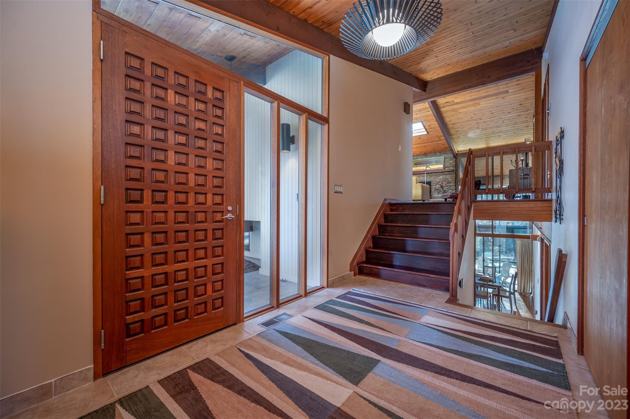 548 Howard Gap Road Tryon, NC 28782 - Photo 10 of 48 a view of a hallway with wooden floor and staircase