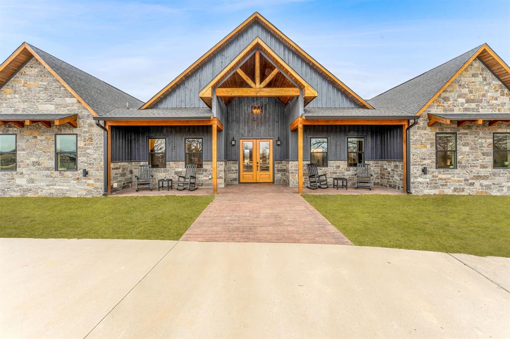 239 32507th Road Paris, TX 75460 - Photo 15 of 40 View of front of property with stone siding, a front yard, a porch, and french doors