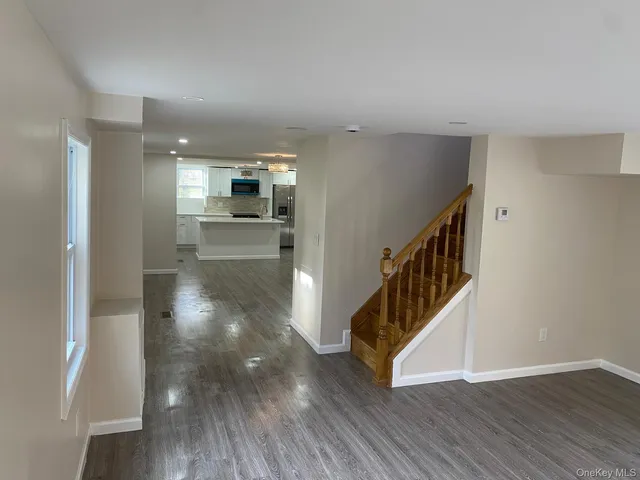 a view of hallway with wooden floor