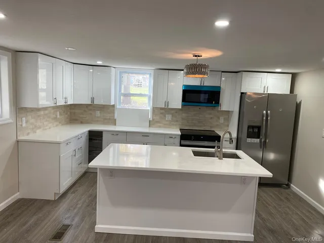 a kitchen with granite countertop a stove and a refrigerator