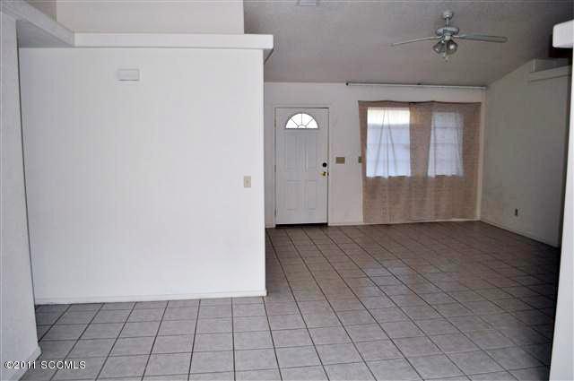 888 Via Puebla Rio Rico, AZ 85648 - Photo 6 of 11 an empty room with wooden floor and windows